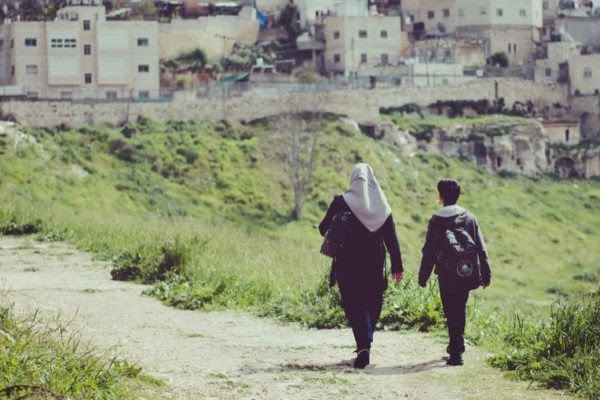 A Palestinian woman and an Israeli boy walking peacefully together. Is this picture a sign of hope?